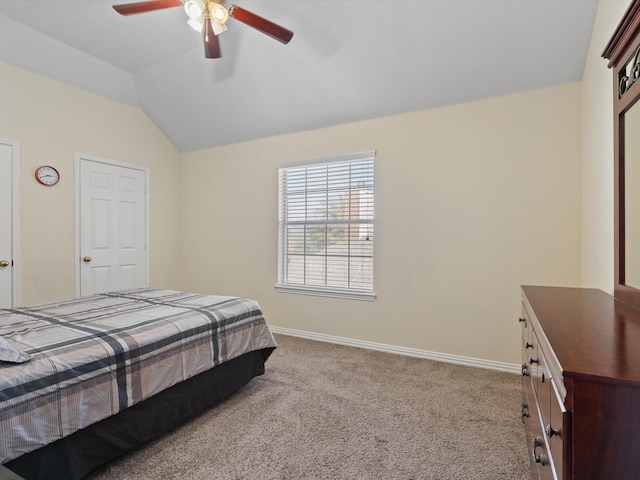 bedroom featuring light carpet, lofted ceiling, and ceiling fan