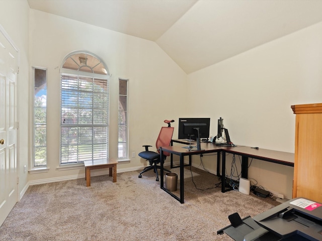 carpeted office space with vaulted ceiling