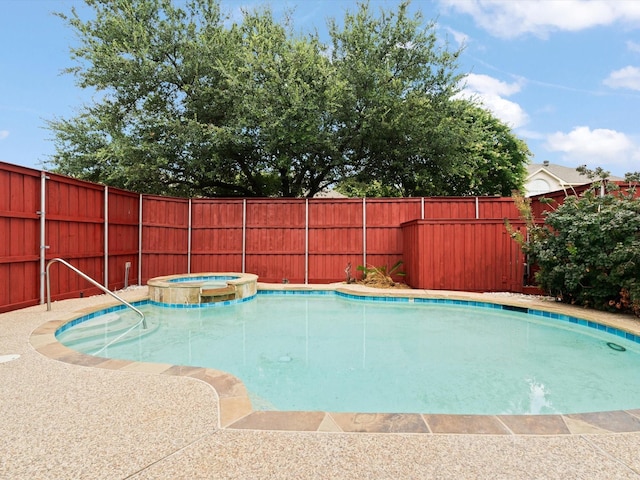 view of swimming pool with an in ground hot tub