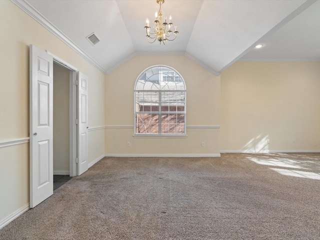 carpeted empty room with vaulted ceiling, ornamental molding, and a notable chandelier