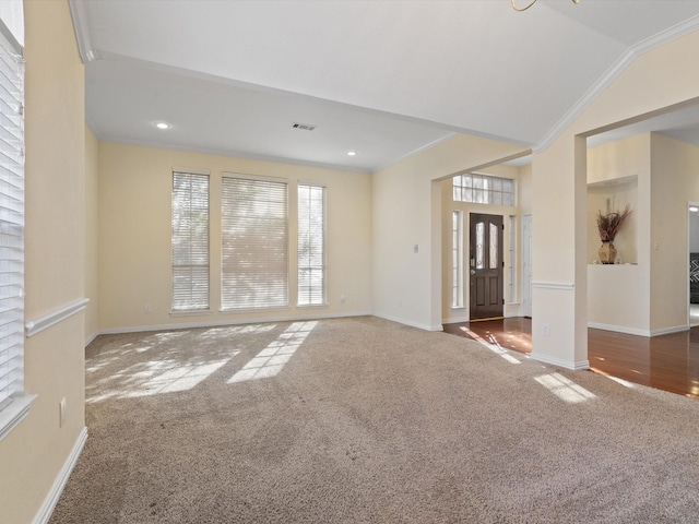 interior space featuring ornamental molding and lofted ceiling