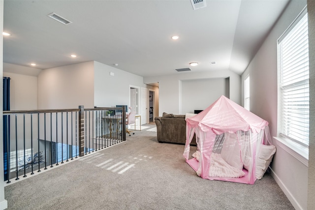 recreation room with lofted ceiling, carpet floors, and a wealth of natural light