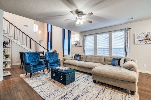 living room featuring ceiling fan and wood-type flooring