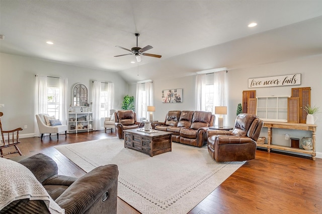 living room with wood-type flooring, vaulted ceiling, and ceiling fan