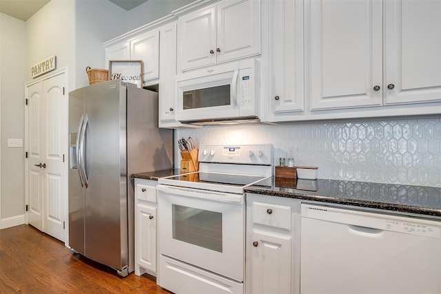 kitchen with dark wood-type flooring, white cabinets, white appliances, and decorative backsplash