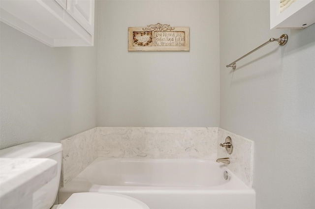 bathroom with a bathing tub and toilet