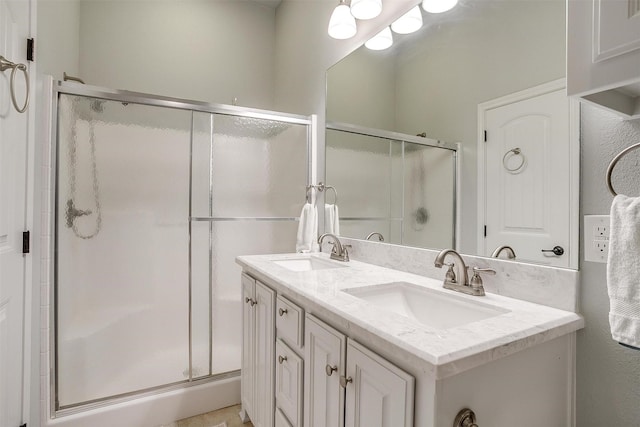 bathroom with vanity and a shower with door