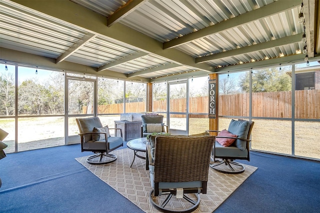 sunroom featuring beamed ceiling and a wealth of natural light