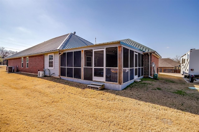 back of property with cooling unit and a sunroom