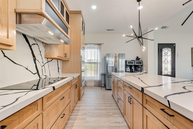 kitchen featuring light brown cabinetry, stainless steel appliances, custom exhaust hood, and light stone countertops