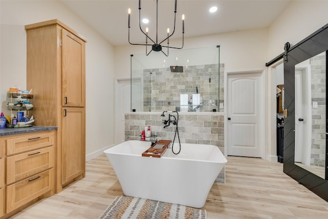 bathroom featuring separate shower and tub and wood-type flooring