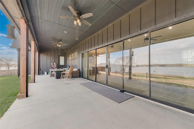 view of patio / terrace with a water view, outdoor lounge area, and ceiling fan