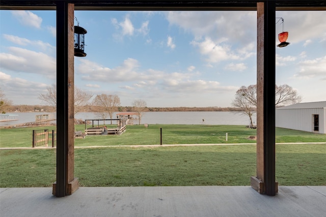 view of property's community with a yard and a water view