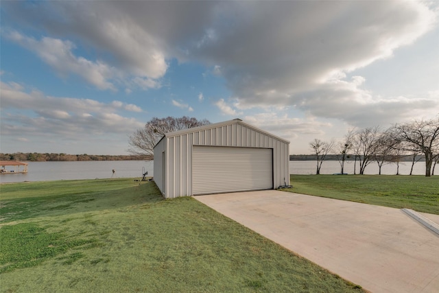 garage featuring a yard and a water view