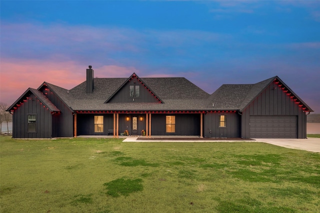 view of front of house with a garage and a lawn