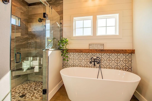 bathroom featuring separate shower and tub