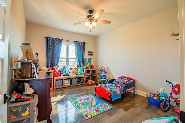 playroom featuring dark hardwood / wood-style floors and ceiling fan