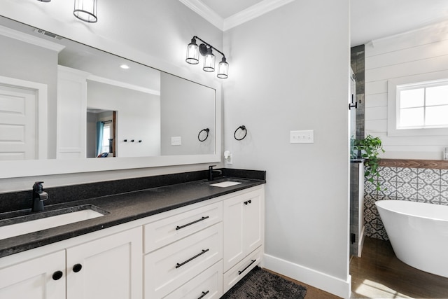 full bath with visible vents, a sink, crown molding, and wood finished floors