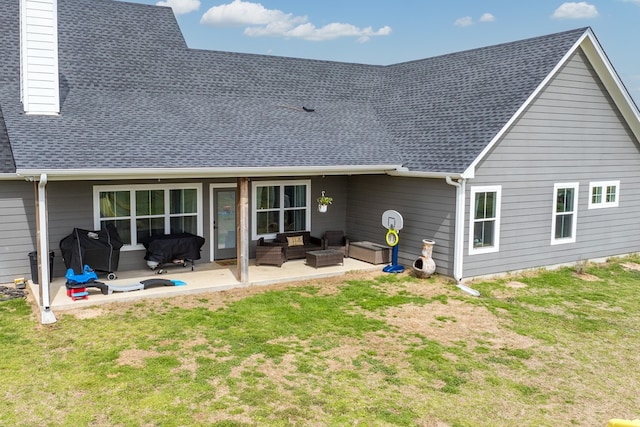 rear view of house with outdoor lounge area, a lawn, a patio area, a chimney, and a shingled roof