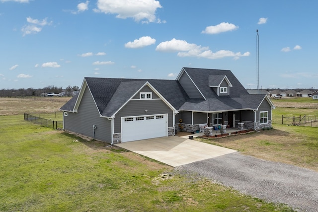 craftsman-style home with an attached garage, covered porch, fence, a front lawn, and driveway