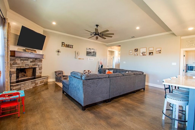 living room featuring dark hardwood / wood-style flooring, ornamental molding, ceiling fan, and a fireplace