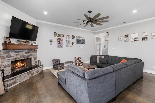 living area featuring dark wood-style flooring, baseboards, a fireplace, visible vents, and ceiling fan