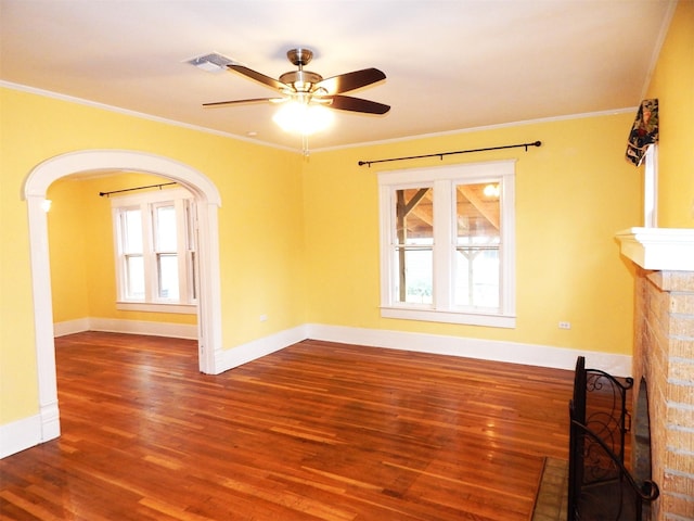 unfurnished living room featuring hardwood / wood-style floors, a fireplace, ornamental molding, and ceiling fan