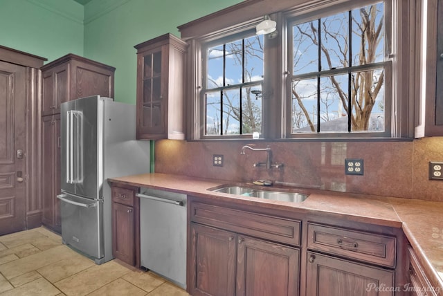 kitchen featuring stainless steel appliances, sink, and decorative backsplash