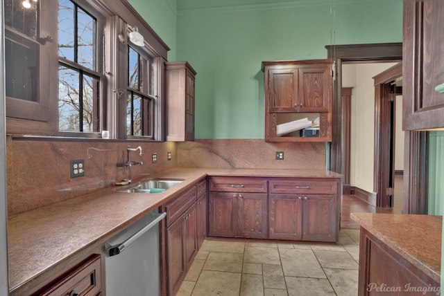 kitchen with tasteful backsplash, dishwasher, and sink