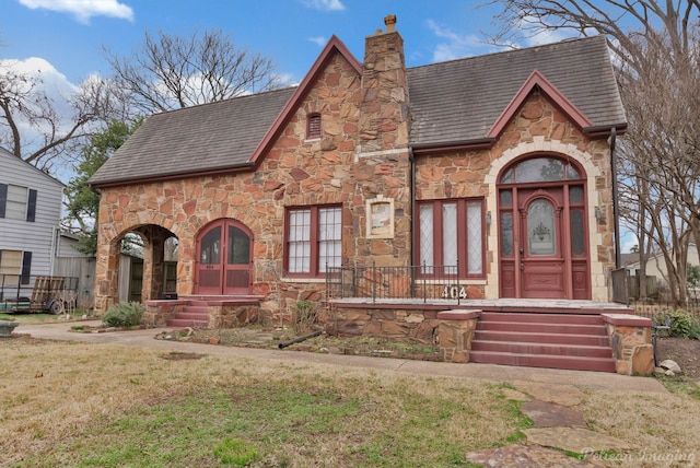 tudor home featuring a front yard