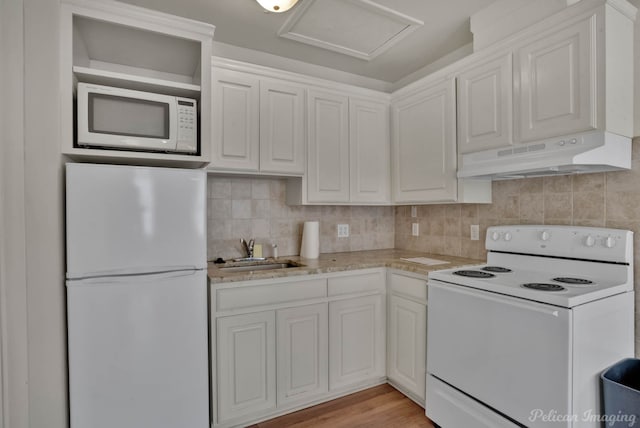 kitchen featuring sink, tasteful backsplash, light wood-type flooring, white appliances, and white cabinets