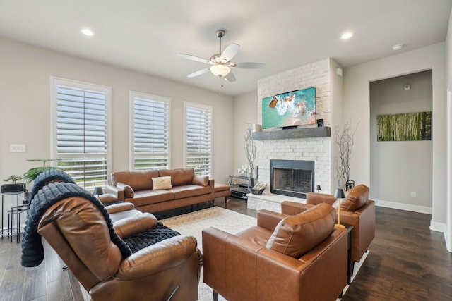 living room with dark hardwood / wood-style flooring, a fireplace, and a wealth of natural light