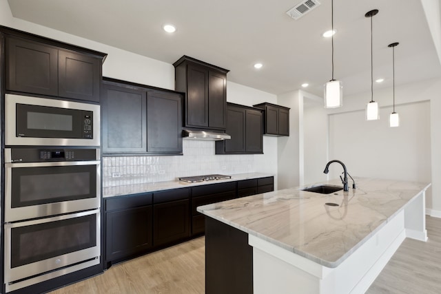 120 Bristol Ln, Azle, TX 76020 - kitchen with stainless steel appliances, light wood-style flooring, tasteful backsplash, light stone counters, and recessed lighting