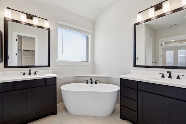 120 Bristol Ln, Azle, TX 76020 - full bathroom with two vanities and a freestanding tub