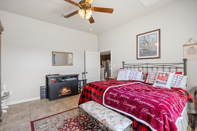 tiled bedroom featuring ceiling fan