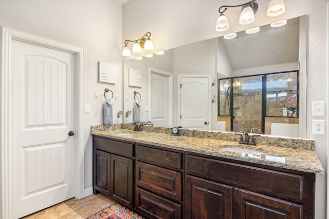 bathroom featuring an enclosed shower, vanity, tile patterned flooring, and vaulted ceiling