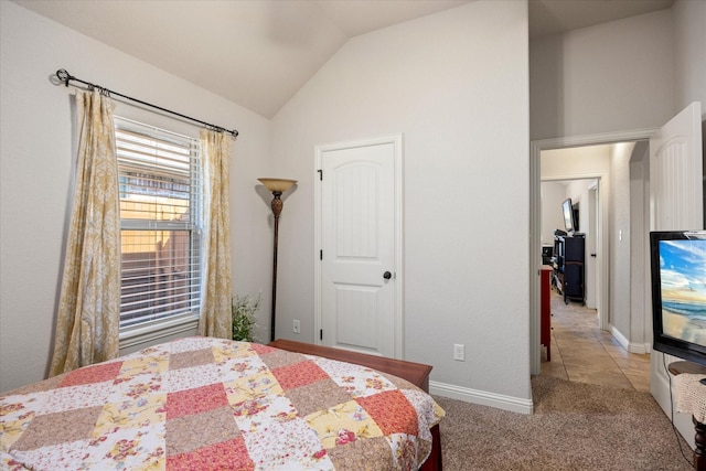 bedroom with vaulted ceiling and light colored carpet