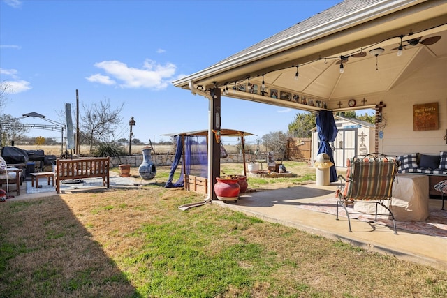 view of yard featuring a gazebo, a patio area, and a shed