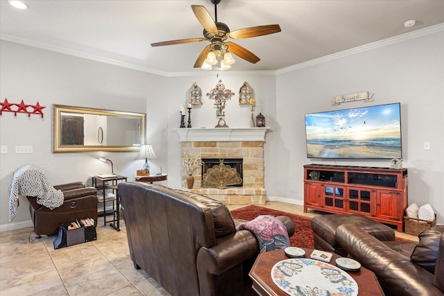 tiled living room featuring crown molding, a stone fireplace, and ceiling fan