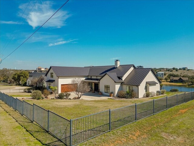 view of front of property with a garage and a yard