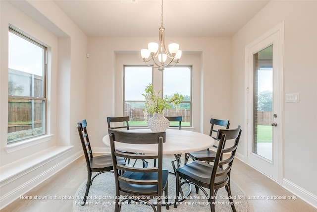 dining area featuring a chandelier and light hardwood / wood-style flooring