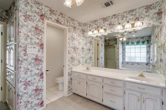 full bathroom with tile patterned floors, toilet, a textured ceiling, vanity, and ceiling fan