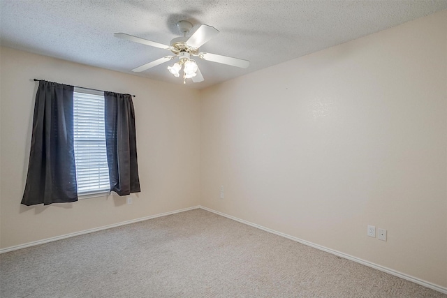 unfurnished room with ceiling fan, carpet floors, and a textured ceiling