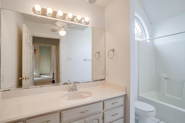 full bathroom featuring ceiling fan, vanity, toilet, and tub / shower combination