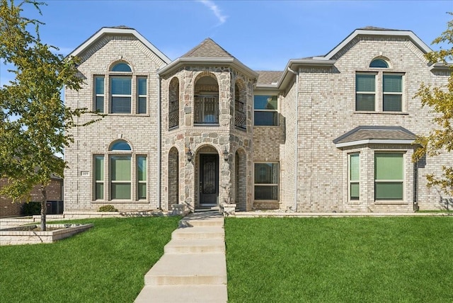 french country style house with a front lawn