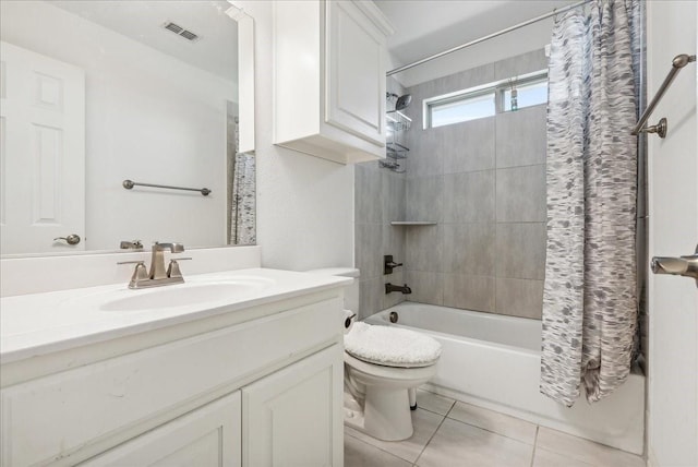 full bathroom featuring tile patterned flooring, vanity, toilet, and shower / bath combo with shower curtain