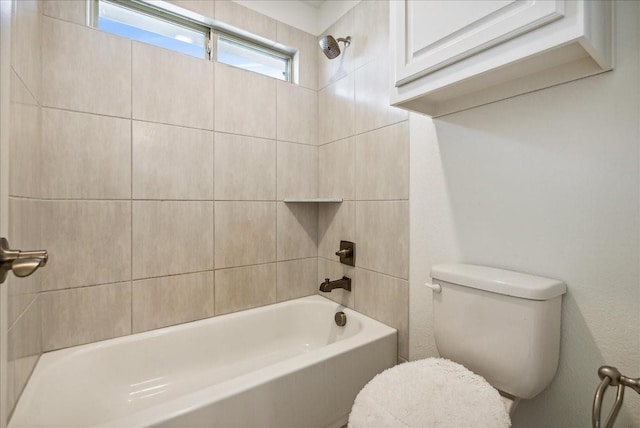 bathroom featuring tiled shower / bath and toilet