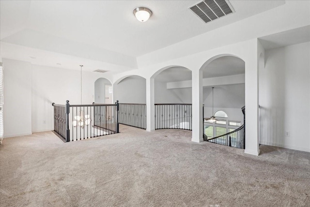 carpeted spare room with ceiling fan