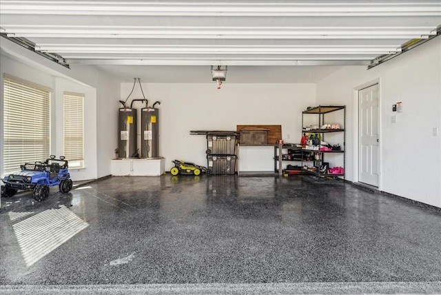 garage with a garage door opener and electric water heater