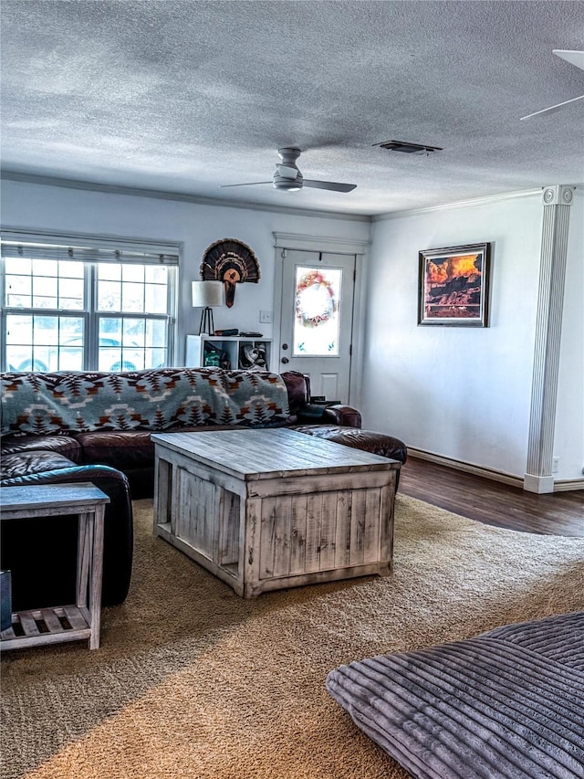 living room with a textured ceiling and ceiling fan